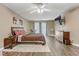 A spacious main bedroom featuring hardwood floors, a plush area rug, and large windows at 1730 Juniper Twig Ave, Las Vegas, NV 89183