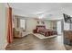 A spacious main bedroom featuring hardwood floors, a plush area rug, and large windows at 1730 Juniper Twig Ave, Las Vegas, NV 89183