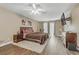 A spacious main bedroom featuring hardwood floors, a plush area rug, and large windows at 1730 Juniper Twig Ave, Las Vegas, NV 89183