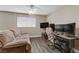 Functional office space with a comfortable couch, desk, and multiple monitors for productivity at 1730 Juniper Twig Ave, Las Vegas, NV 89183