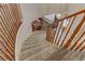 Elegant staircase featuring carpeted steps and wood railing that leads to the lower level at 1730 Juniper Twig Ave, Las Vegas, NV 89183