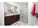 Bathroom featuring double sinks, tile flooring, and glass-enclosed shower at 1819 Wild Grain Ave, North Las Vegas, NV 89086