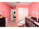 Pink Bedroom featuring a crib, closet and neutral carpet at 1819 Wild Grain Ave, North Las Vegas, NV 89086