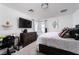 Bright bedroom with a comfortable bed, TV, work desk and natural light at 1819 Wild Grain Ave, North Las Vegas, NV 89086