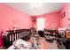 Pink Bedroom with a crib, changing table, chair, and plenty of space at 1819 Wild Grain Ave, North Las Vegas, NV 89086