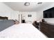 Well-lit bedroom with a large bed, TV, work desk and doorway to the bathroom at 1819 Wild Grain Ave, North Las Vegas, NV 89086