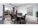 Bright dining room features a wooden table with upholstered chairs and a sliding glass door at 1819 Wild Grain Ave, North Las Vegas, NV 89086