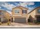 Charming two-story home featuring a welcoming facade, gray garage, and desert landscaping for a modern appeal at 1819 Wild Grain Ave, North Las Vegas, NV 89086