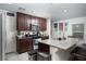 Well-lit kitchen features granite counters, stainless appliances, and dark wood cabinetry at 1819 Wild Grain Ave, North Las Vegas, NV 89086