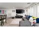 Spacious living room includes a sectional couch, large television and neutral carpet at 1819 Wild Grain Ave, North Las Vegas, NV 89086