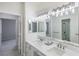 Bright bathroom boasts double sinks, marble countertops and a view of a shower room at 1865 Woodhaven Dr, Henderson, NV 89074