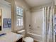 Well-lit bathroom with shower-tub combination and shuttered window at 1973 Ardilea St, Las Vegas, NV 89135