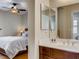 Bathroom with dual mirrors, wood cabinets and adjoining bedroom view at 1973 Ardilea St, Las Vegas, NV 89135