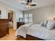 Inviting bedroom featuring a ceiling fan, wood floors, a closet, and a comfortable king bed at 1973 Ardilea St, Las Vegas, NV 89135
