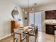 Elegant dining area with modern lighting, a stylish table setting, and convenient access to the kitchen at 1973 Ardilea St, Las Vegas, NV 89135