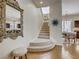 Inviting entryway showcasing a staircase, ornate mirror, and a glimpse of the dining and kitchen areas at 1973 Ardilea St, Las Vegas, NV 89135