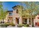 Charming two-story home with a small balcony, inviting front porch, and manicured landscaping at 1973 Ardilea St, Las Vegas, NV 89135
