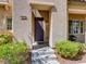 Inviting front entrance with a covered porch, stylish door, and well-manicured shrubs creating curb appeal at 1973 Ardilea St, Las Vegas, NV 89135