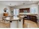 Open-concept kitchen featuring a large island, stainless steel appliances, and a seamless transition to the dining area at 1973 Ardilea St, Las Vegas, NV 89135