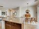 Open-concept kitchen featuring a granite island and an adjacent dining area with modern light fixtures at 1973 Ardilea St, Las Vegas, NV 89135