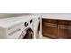 Modern laundry room with front-load washer and dryer and ample cabinet space at 1973 Ardilea St, Las Vegas, NV 89135