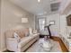 Bright living room featuring a tufted sofa, round glass table, and modern decor at 1973 Ardilea St, Las Vegas, NV 89135
