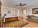 Spacious bedroom with wood floors, a ceiling fan, a chaise lounge and an ensuite bathroom at 1973 Ardilea St, Las Vegas, NV 89135