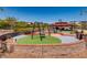 Community playground featuring swings, a covered picnic area, and safety-conscious surfacing at 1973 Ardilea St, Las Vegas, NV 89135