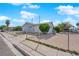 Modest home featuring a chain link fence, desert landscaping and mature landscaping at 2012 Wendell Ave, Las Vegas, NV 89101
