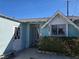 Charming exterior of a single-story home featuring a unique diamond pane door and an address marked above the window at 2012 Wendell Ave, Las Vegas, NV 89101