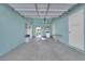 Spacious garage with light blue painted walls and concrete floor, featuring rear door access at 2012 Wendell Ave, Las Vegas, NV 89101