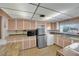 Bright kitchen with a stainless steel refrigerator, white appliances, and ample cabinetry at 2012 Wendell Ave, Las Vegas, NV 89101