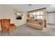 Cozy living room with plush seating, vintage decorations, and carpet flooring at 2012 Wendell Ave, Las Vegas, NV 89101