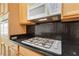Close up of the kitchen, showcasing gas cooktop, microwave, and granite countertops at 2052 Powder Springs St, Henderson, NV 89052