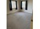Inviting bedroom featuring carpet, light-filled windows with dark curtains and neutral walls at 221 Oro Canyon St, Henderson, NV 89074