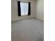 Empty bedroom featuring neutral carpet, paint, a window with curtains and abundant natural light at 221 Oro Canyon St, Henderson, NV 89074