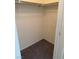 Compact walk-in closet with carpeting, and a hanging rod, awaits personal organization and style at 221 Oro Canyon St, Henderson, NV 89074