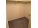Empty walk-in closet ready for organizing, featuring carpeting and a hanging rod for storage at 221 Oro Canyon St, Henderson, NV 89074