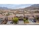 Panoramic aerial view of a peaceful neighborhood with beautiful homes nestled against a backdrop of majestic mountains at 231 Pioneers Peak Ave, Henderson, NV 89002