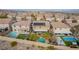Aerial view of neighborhood with pools, solar panels, and landscaped yards, creating an inviting community atmosphere at 231 Pioneers Peak Ave, Henderson, NV 89002