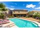 A backyard featuring a refreshing pool, cozy lounge chairs, and a serene hammock for relaxation at 231 Pioneers Peak Ave, Henderson, NV 89002