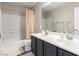 Bathroom with double vanity, framed mirror, bath tub and shower with curtain at 231 Pioneers Peak Ave, Henderson, NV 89002