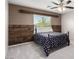 Bedroom featuring a ceiling fan, a window letting in natural light and wood accent wall at 231 Pioneers Peak Ave, Henderson, NV 89002