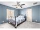 Blue bedroom featuring a ceiling fan, large window, and lots of light at 231 Pioneers Peak Ave, Henderson, NV 89002