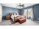 Bedroom featuring a ceiling fan, wood bed frame, and windows letting in natural light at 231 Pioneers Peak Ave, Henderson, NV 89002