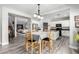 Open-concept dining room with stairs, connecting the kitchen and living room in the background at 231 Pioneers Peak Ave, Henderson, NV 89002
