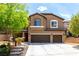 Beautiful two-story home with a two-car garage, desert landscaping and covered porch at 231 Pioneers Peak Ave, Henderson, NV 89002