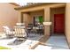 Inviting front porch featuring comfortable seating, a charming red door, and a welcoming ambiance at 231 Pioneers Peak Ave, Henderson, NV 89002