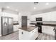 Modern kitchen with white cabinets, stainless steel appliances, granite countertops, and a center island at 231 Pioneers Peak Ave, Henderson, NV 89002