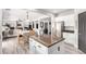 Open-concept kitchen featuring granite countertops, a kitchen island, and stainless steel appliances at 231 Pioneers Peak Ave, Henderson, NV 89002